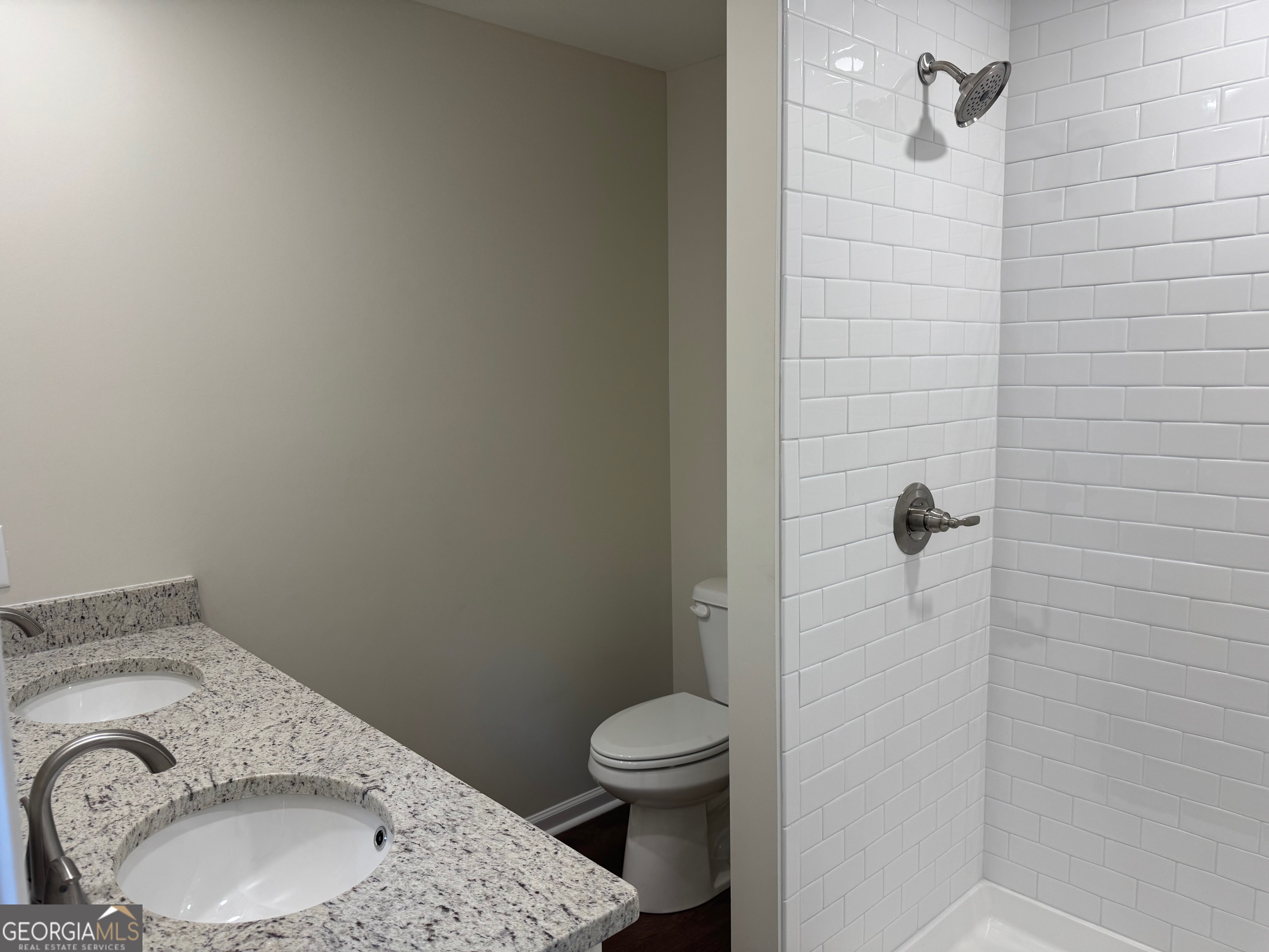 2809 Jones Road Sandersville, GA 31082 - Photo 26 of 31 a bathroom with a granite countertop toilet and a sink