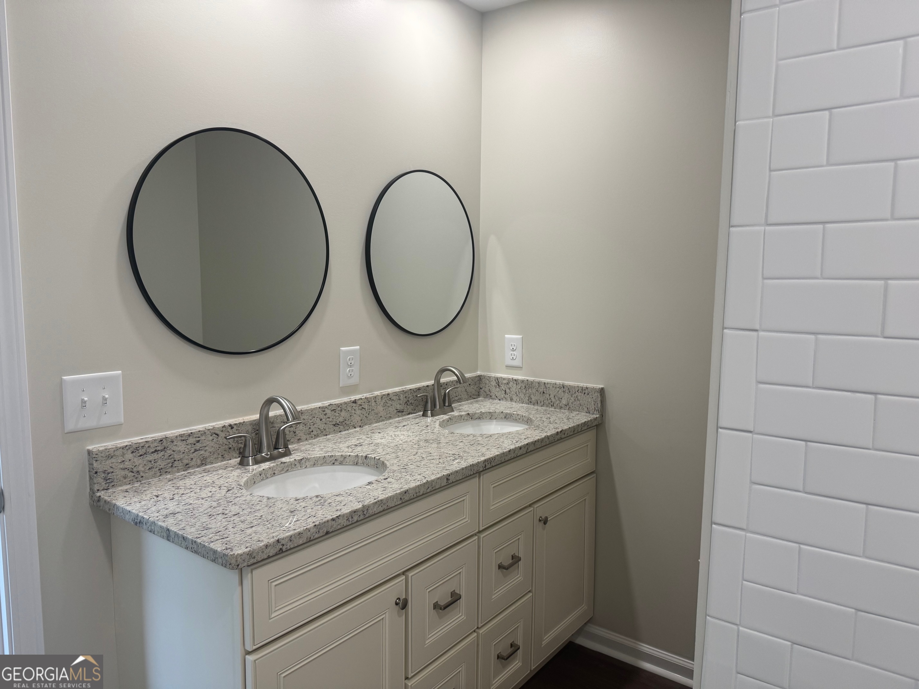 2809 Jones Road Sandersville, GA 31082 - Photo 27 of 31 a bathroom with a granite countertop double vanity sink and a mirror