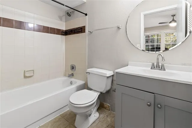 a bathroom with a toilet a sink a mirror a bathtub and shower