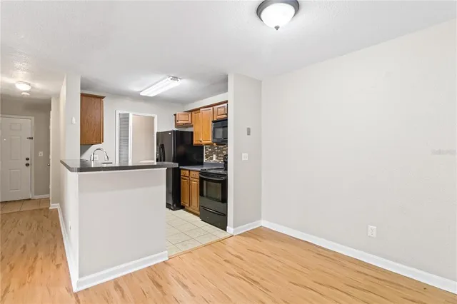 a kitchen with granite countertop a refrigerator and a sink