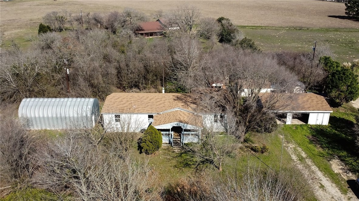 a aerial view of a house with a yard and lake view