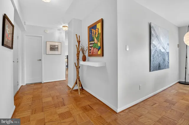 a view of a hallway with paintings on the wall