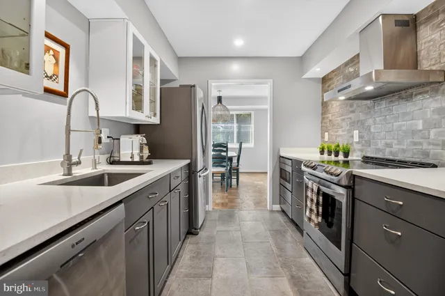 a kitchen with stainless steel appliances granite countertop a sink and cabinets