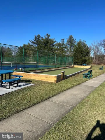 a view of a swimming pool with a yard and sitting area