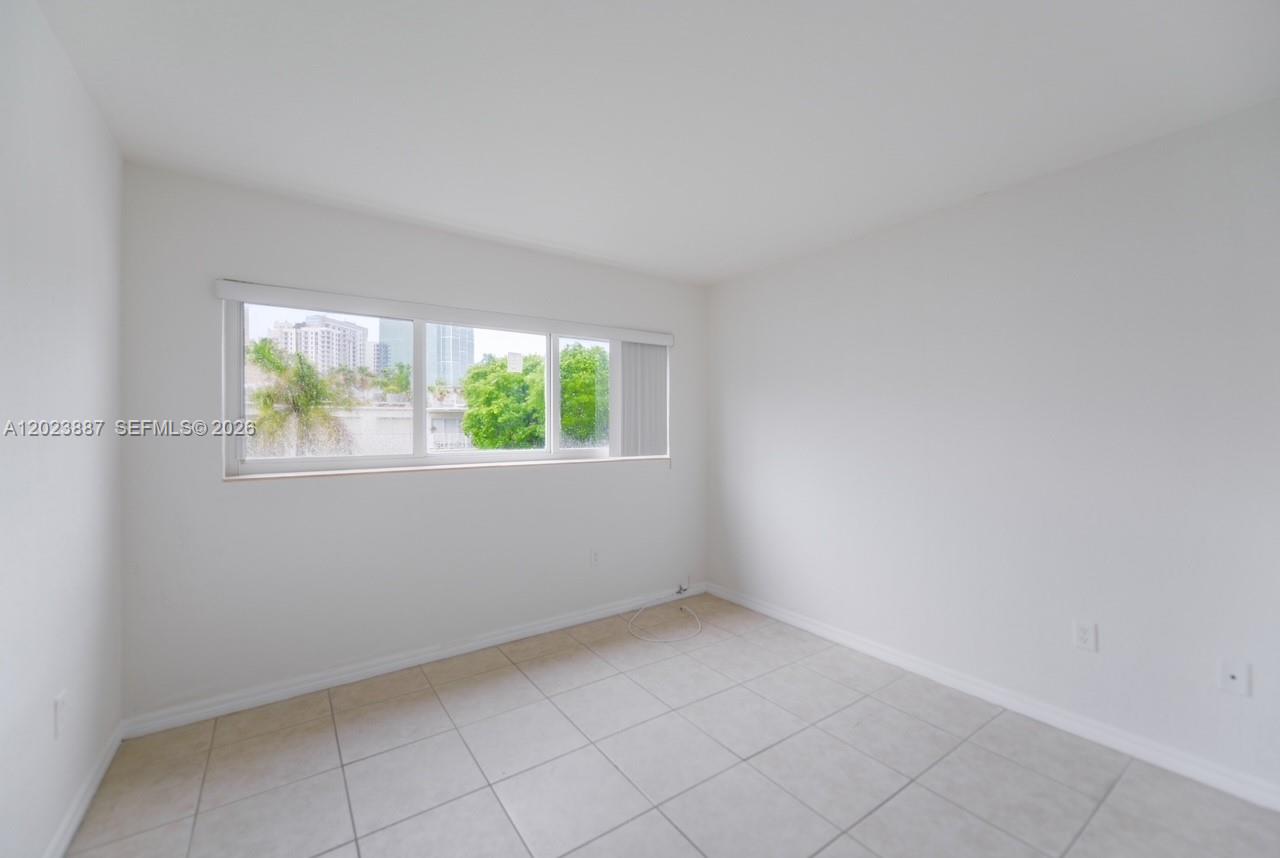 7737 Southwest 88th Street, Unit C312 Miami, FL 33156 - Photo 19 of 32 an empty room with windows