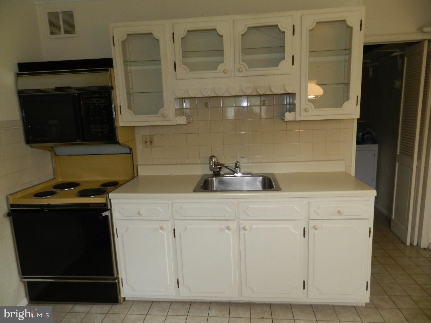 113 Gable Road Paoli, PA 19301 - Photo 2 of 17 a kitchen with white cabinets and a sink