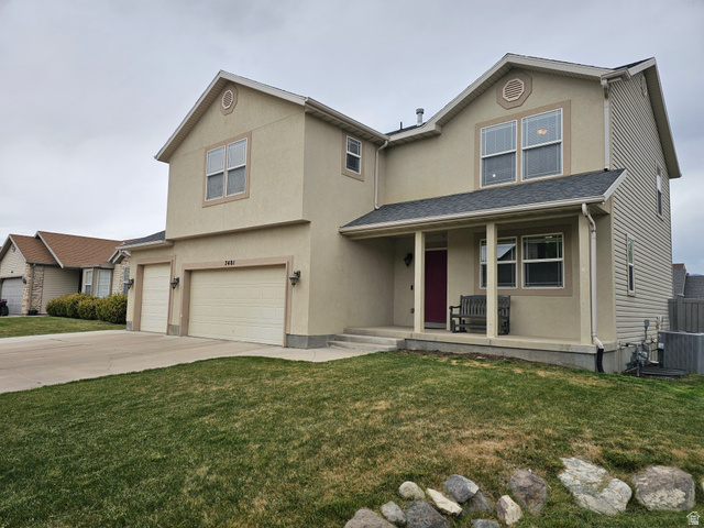 7481 Red Pine Road Eagle Mountain, UT 84005 - Photo 2 of 38 Two-story property featuring a covered front porch, a three-car garage with individual doors, and a stucco and siding exterior