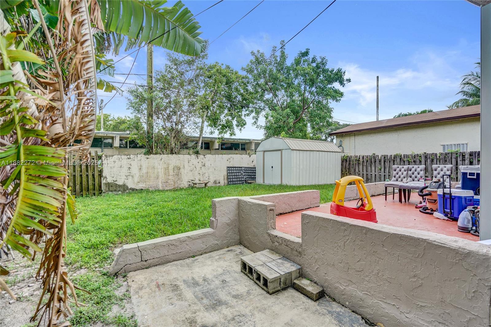 5606 Hayes Street, Unit 2 Hollywood, FL 33021 - Photo 17 of 20 a view of backyard with outdoor seating and trees