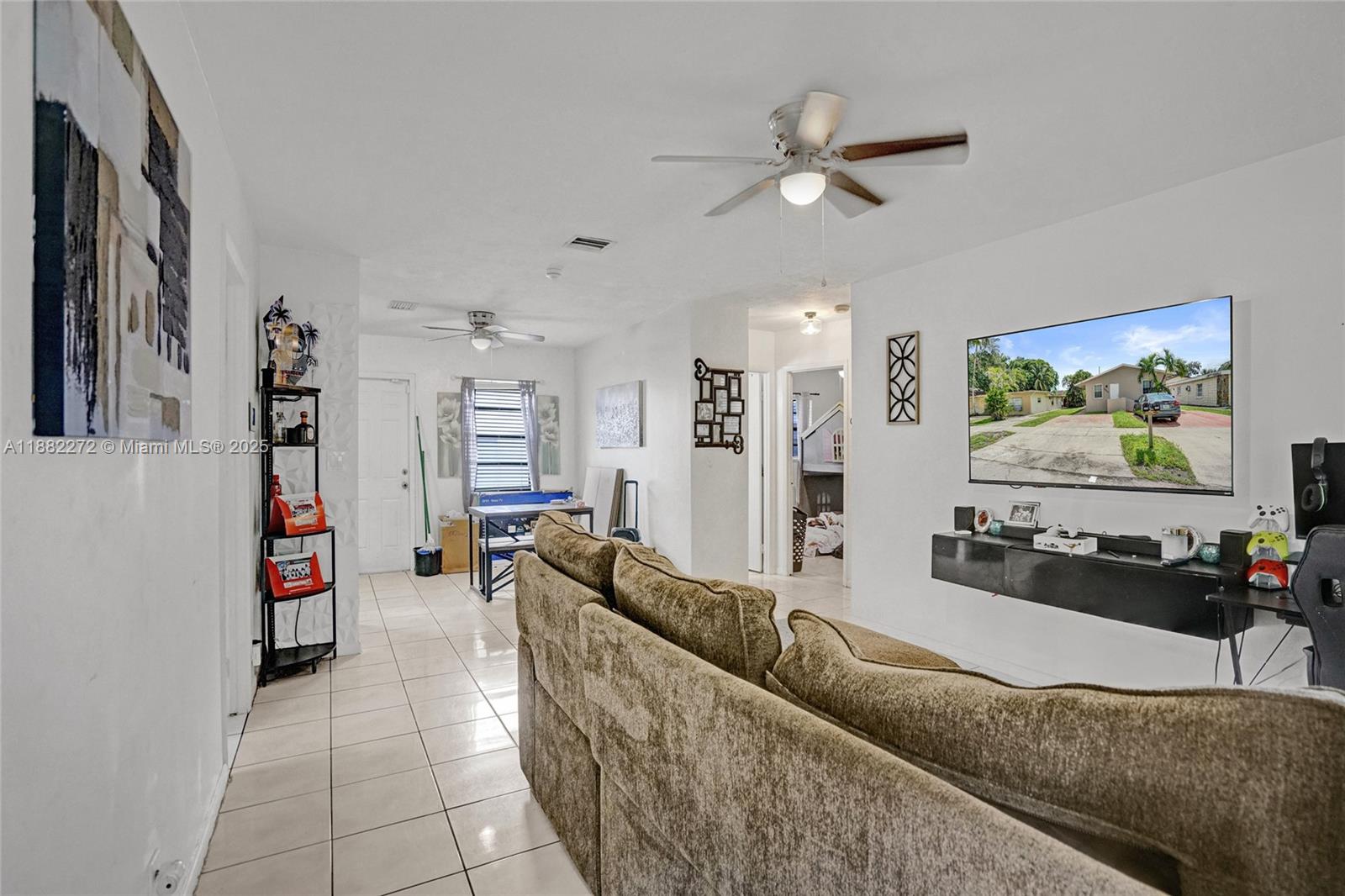 5606 Hayes Street, Unit 2 Hollywood, FL 33021 - Photo 2 of 20 a living room with furniture and a flat screen tv
