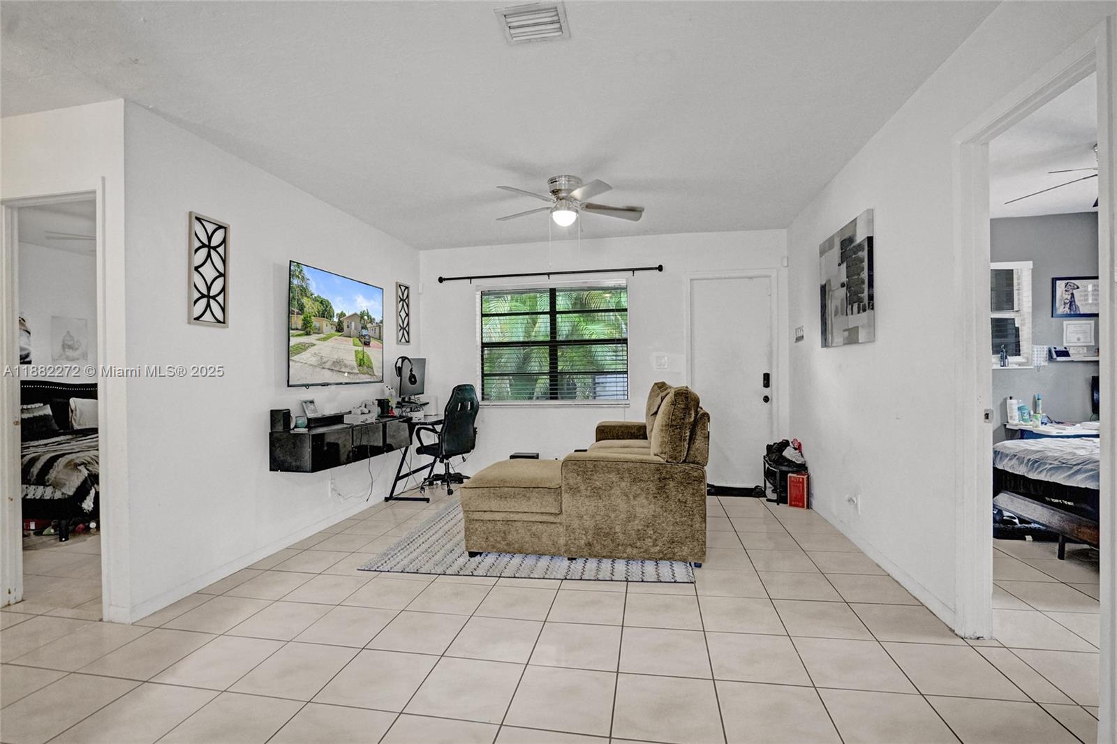 5606 Hayes Street, Unit 2 Hollywood, FL 33021 - Photo 4 of 20 a living room with furniture a flat screen tv and a window