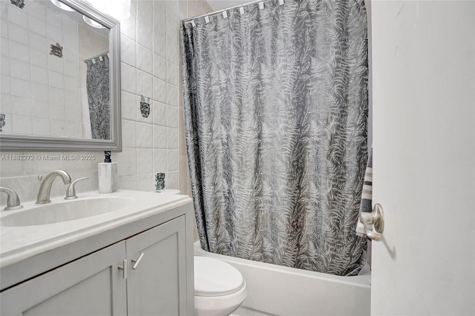 5606 Hayes Street, Unit 2 Hollywood, FL 33021 - Photo 7 of 20 a bathroom with a sink toilet and shower