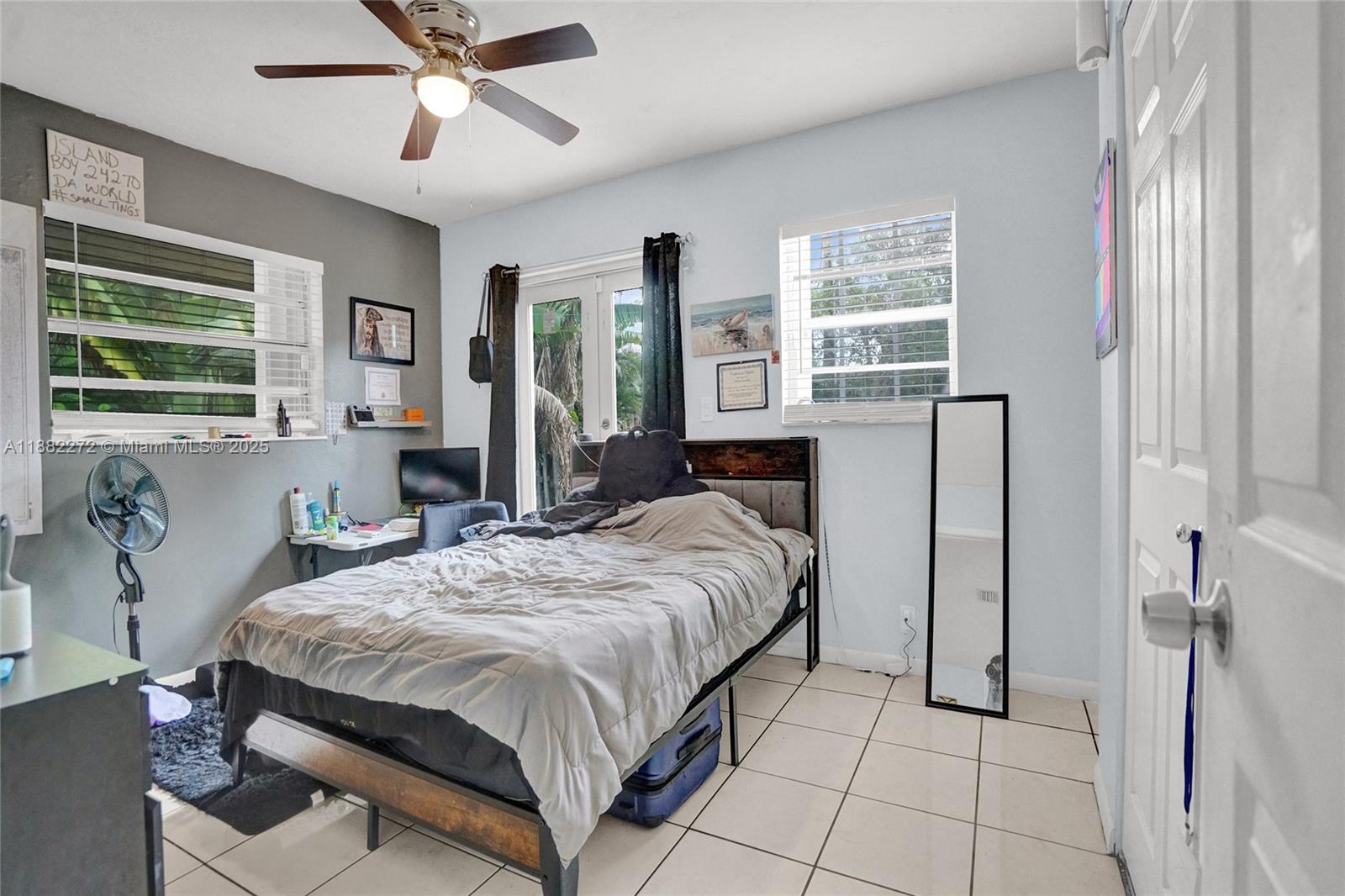 5606 Hayes Street, Unit 2 Hollywood, FL 33021 - Photo 8 of 20 a spacious bedroom with a bed and glass windows