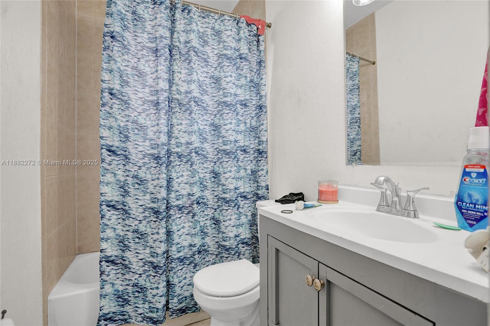 5606 Hayes Street, Unit 2 Hollywood, FL 33021 - Photo 10 of 20 a bathroom with a sink a toilet and a mirror