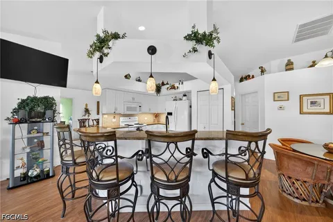 a dining room with furniture and wooden floor