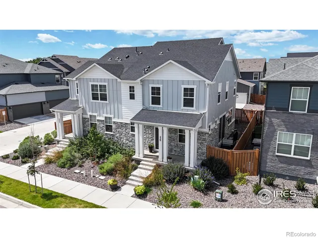 a view of a white house next to a yard