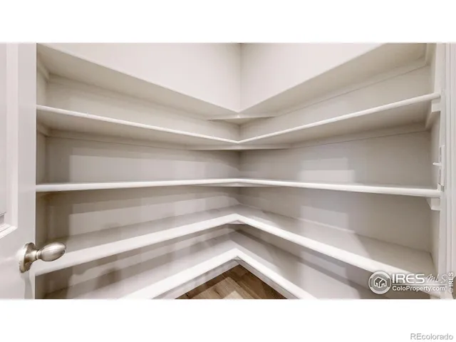 a room with wooden floor and stairs