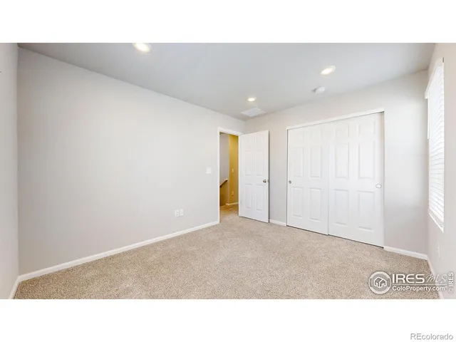 a open hall with a wooden floor and windows