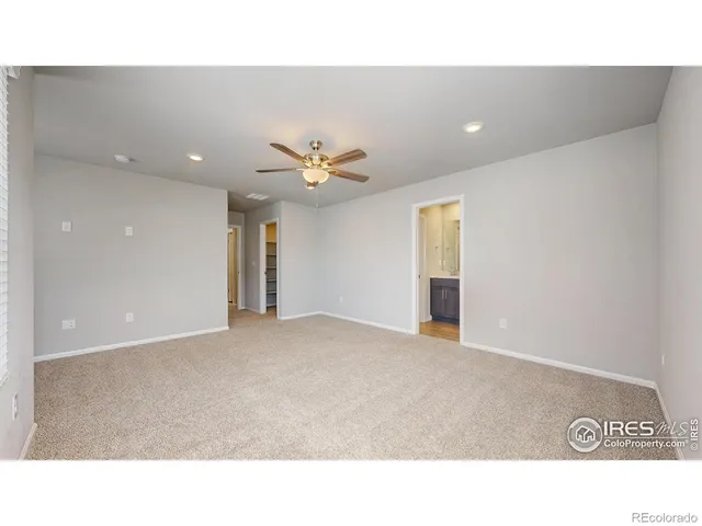 a bathroom with a sink a toilet a large mirror and shower