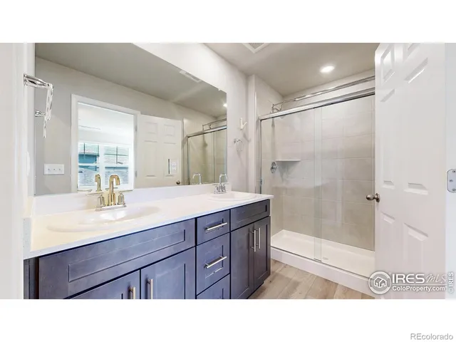 a bathroom with a sink double vanity and a mirror
