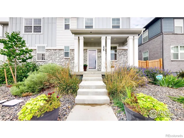 a view of a house with potted plants