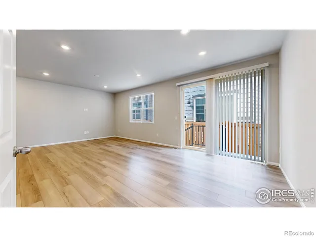 a open hall with wooden floor and window