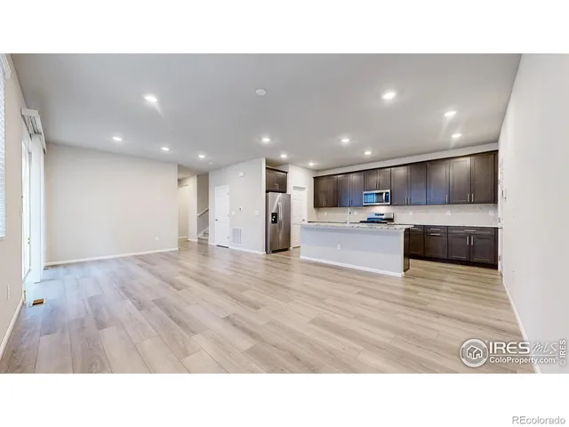a upper view of kitchen with stainless steel appliances kitchen island sink and cabinets