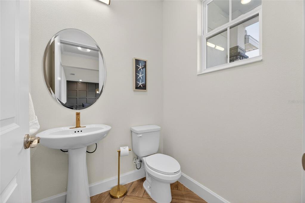 914 Signet Drive Apollo Beach, FL 33572 - Photo 12 of 100 a bathroom with a toilet sink and mirror