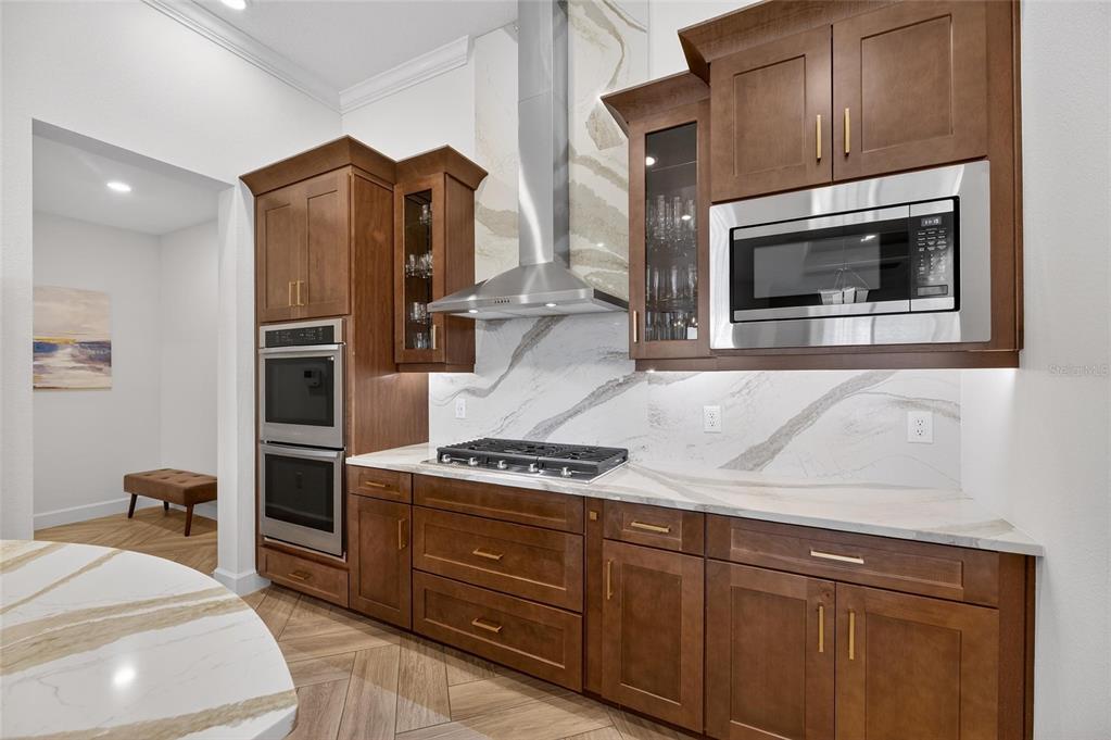 914 Signet Drive Apollo Beach, FL 33572 - Photo 24 of 100 a kitchen with stainless steel appliances granite countertop a stove a microwave and a refrigerator