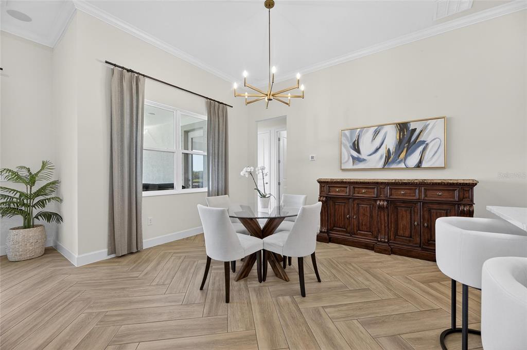 914 Signet Drive Apollo Beach, FL 33572 - Photo 27 of 100 a dining room with furniture a chandelier and wooden floor