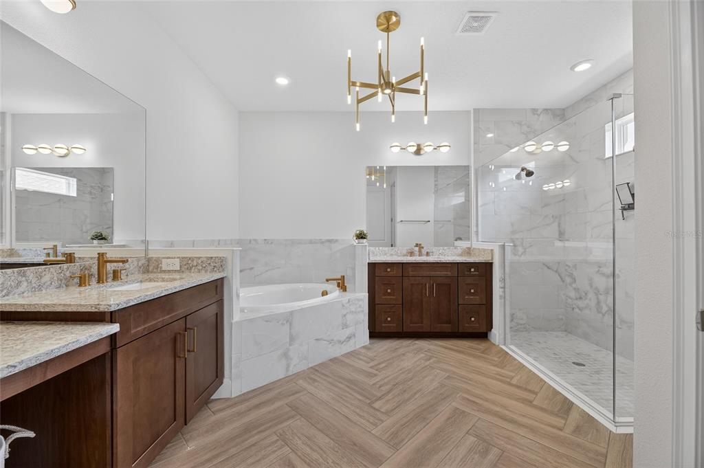 914 Signet Drive Apollo Beach, FL 33572 - Photo 32 of 100 a spacious bathroom with a tub sink shower and mirror