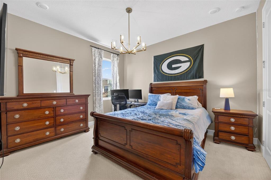 914 Signet Drive Apollo Beach, FL 33572 - Photo 39 of 100 a bedroom with a bed and a dresser