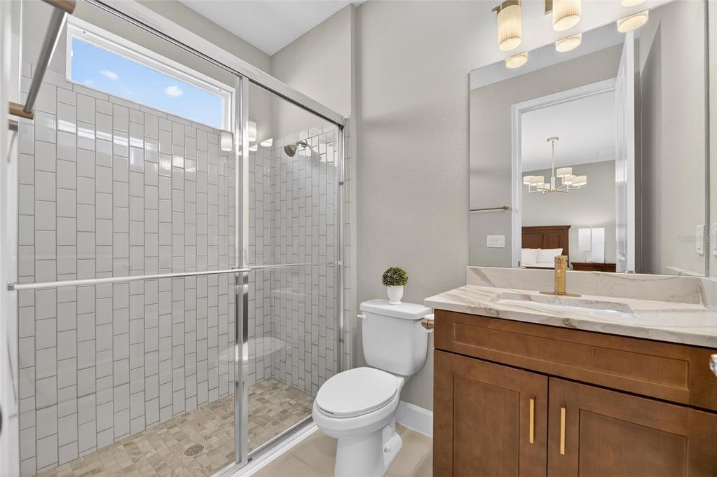 914 Signet Drive Apollo Beach, FL 33572 - Photo 44 of 100 a bathroom with a granite countertop toilet sink and shower