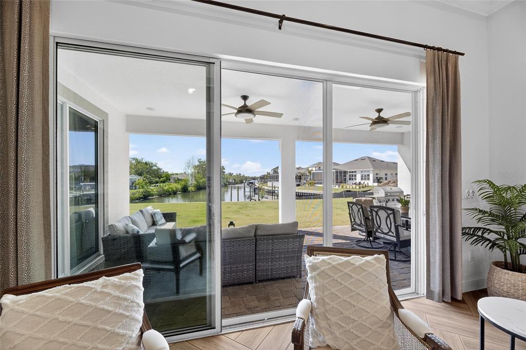 914 Signet Drive Apollo Beach, FL 33572 - Photo 50 of 100 a living room with furniture large windows and wooden floor