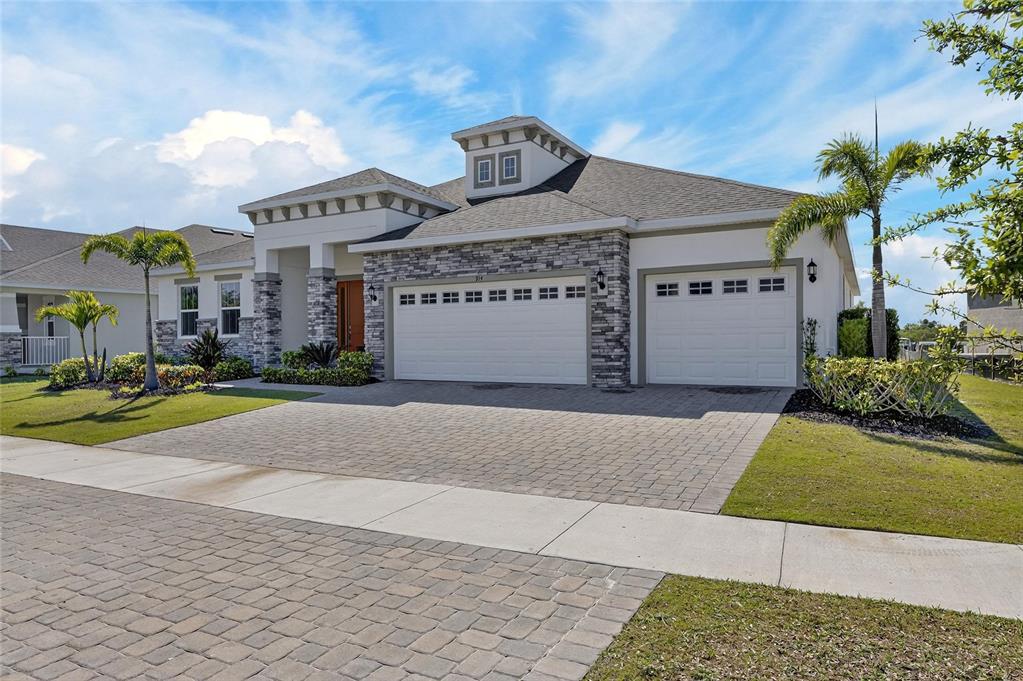 914 Signet Drive Apollo Beach, FL 33572 - Photo 59 of 100 a front view of a house with a garden and plants