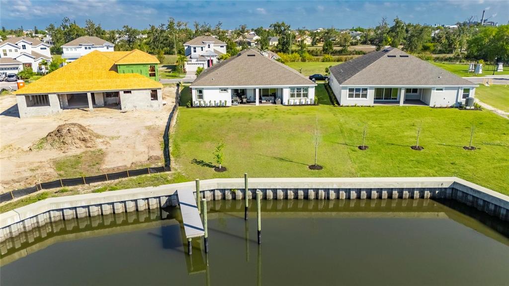 914 Signet Drive Apollo Beach, FL 33572 - Photo 76 of 100 a view of a swimming pool with a lawn chairs under an umbrella