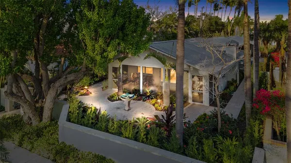 an aerial view of a house with yard swimming pool and outdoor seating