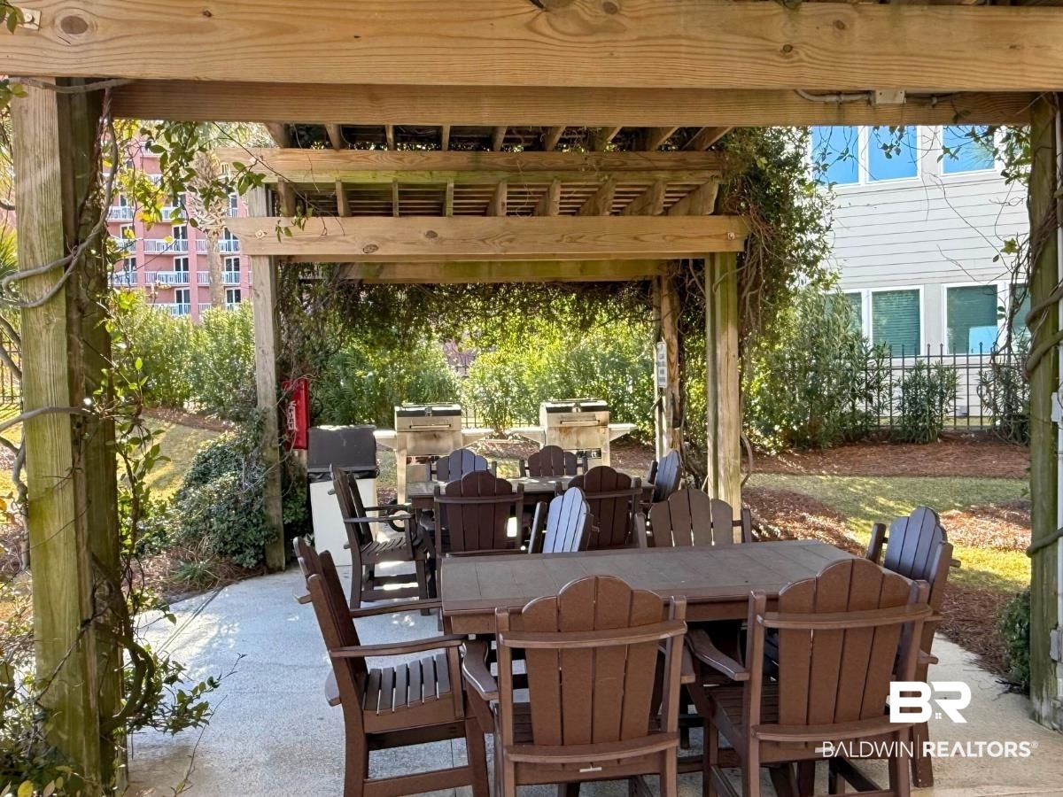 27284 Gulf Road, Unit 212 Orange Beach, AL 36561 - Photo 33 of 35 View of patio featuring outdoor dining area and a pergola