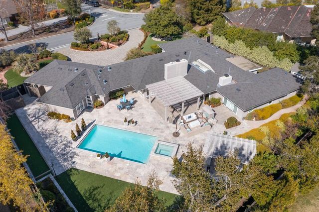 an aerial view of a house with yard swimming pool and outdoor seating