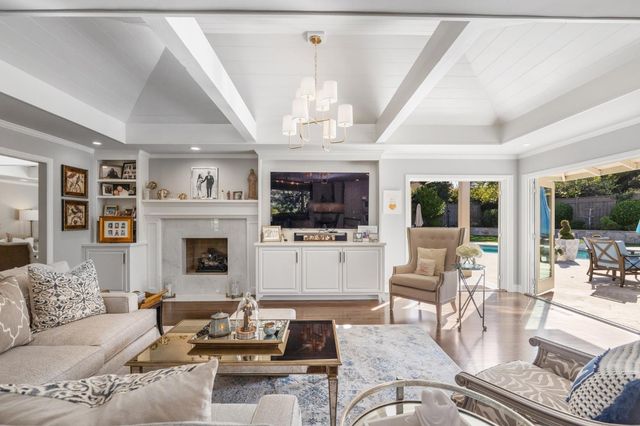 a view of backyard with swimming pool and seating space