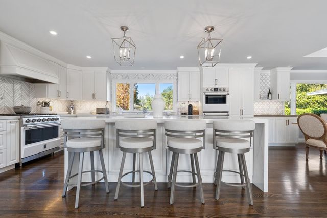 a view of a patio with a table and chairs under an umbrella
