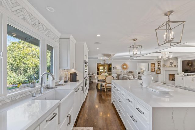 a view of a livingroom with furniture hardwood floor and a chandelier