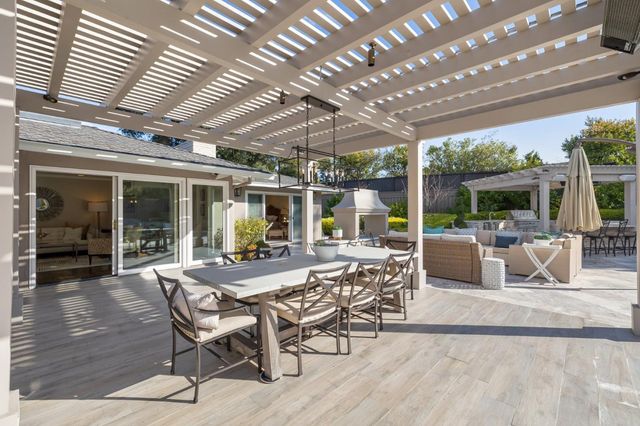 a spacious bathroom with double sink a toilet a shower and a mirror
