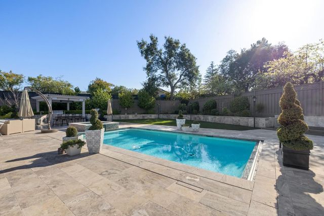 a living room with furniture rug and floor to ceiling window