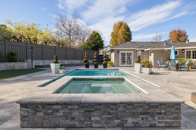 an aerial view of a house with a yard and a large tree