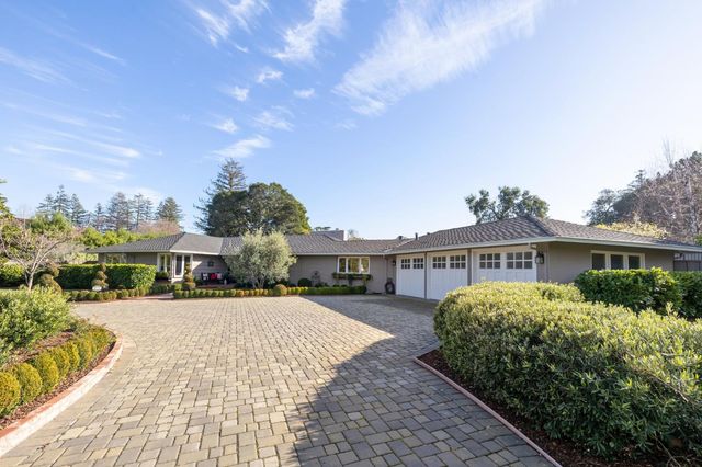 a living room with furniture fireplace and a large window