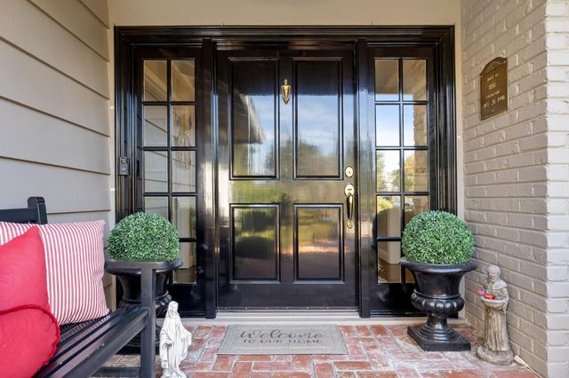 a living room with furniture gym equipment and a large window