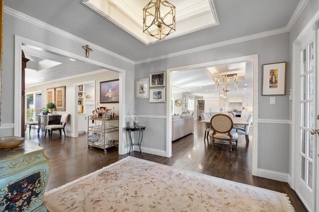 a dining room with furniture a window and wooden floor
