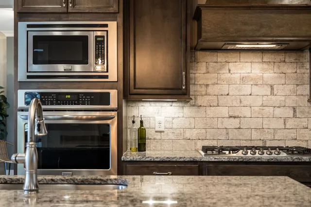 a kitchen with cabinets and stainless steel appliances