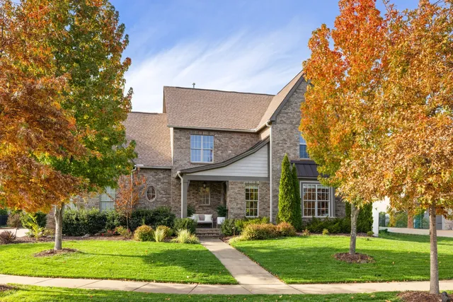 front view of a brick house with a yard