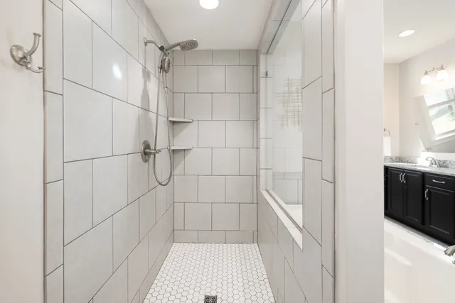 a bedroom with a bed and a couch with window